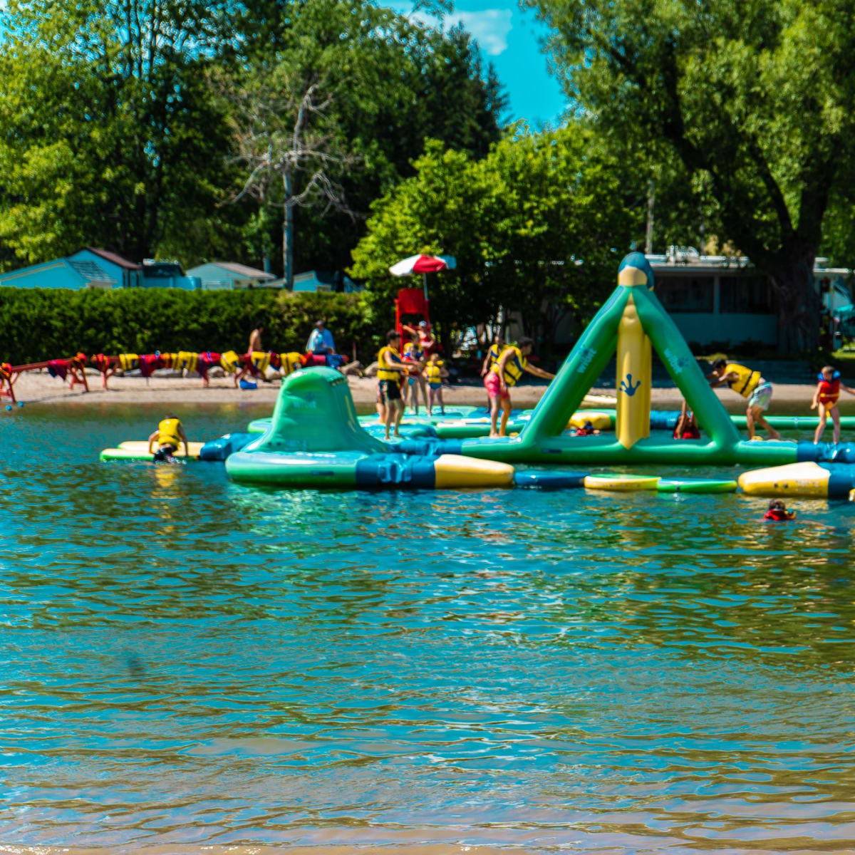 Domaine International de Rouville - A lifeguard looking towards a Wibit inflatable park
