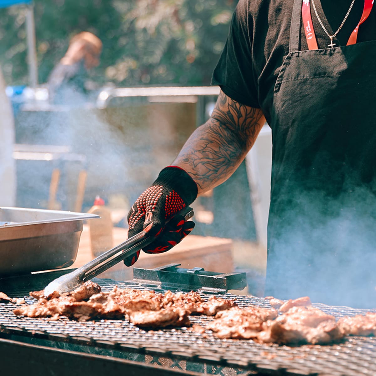 Man grilling meat during Les Rendez-vous gourmands