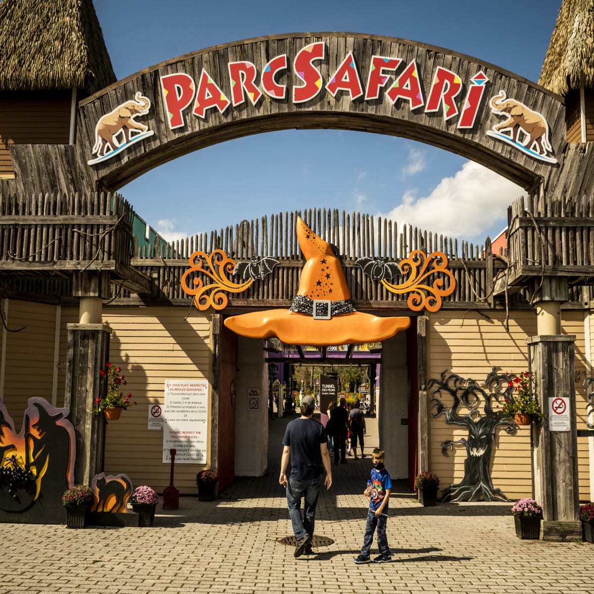 Father and son at the entrance of Parc Safari, decorated for Halloween.