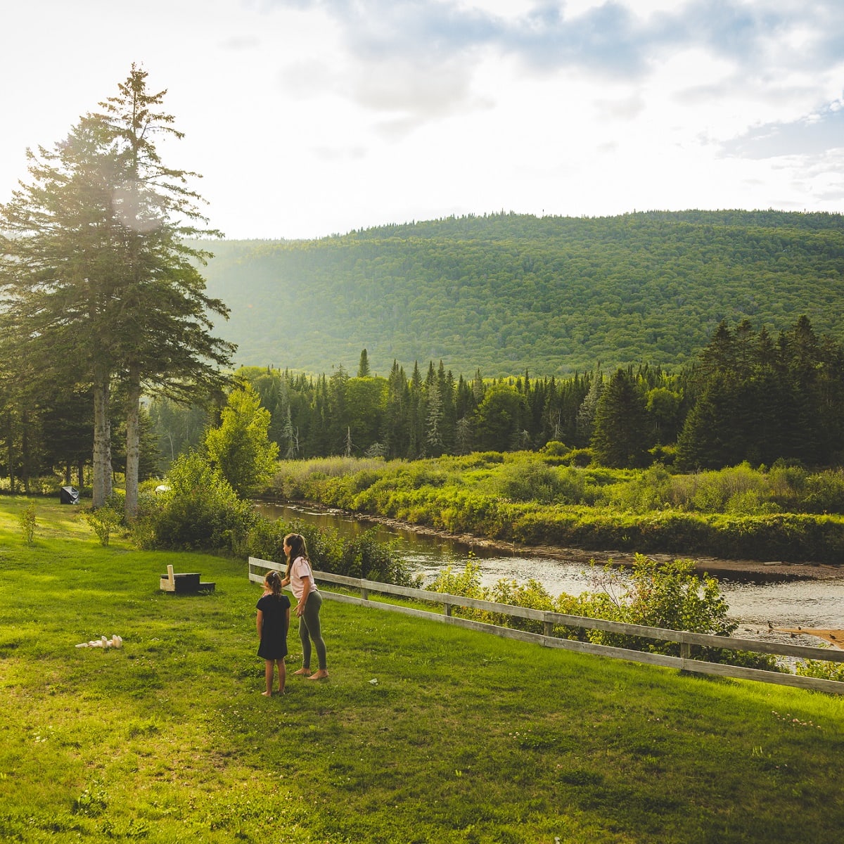 A mother and daughter in a wide-open natural landscape.