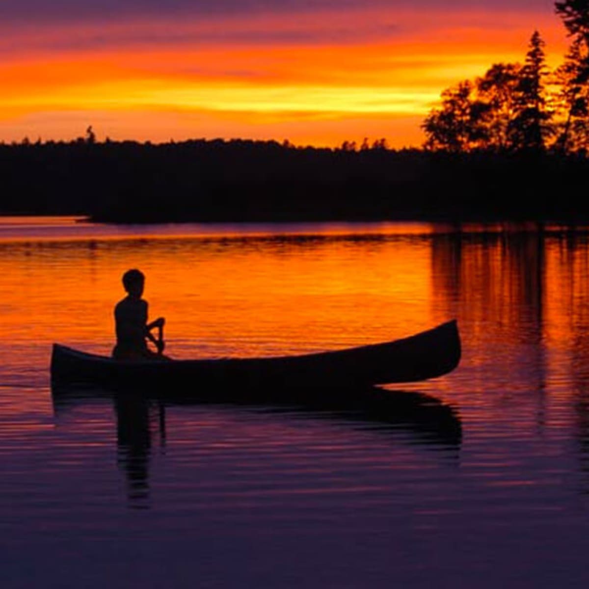 Fishing in a canoe at sunrise