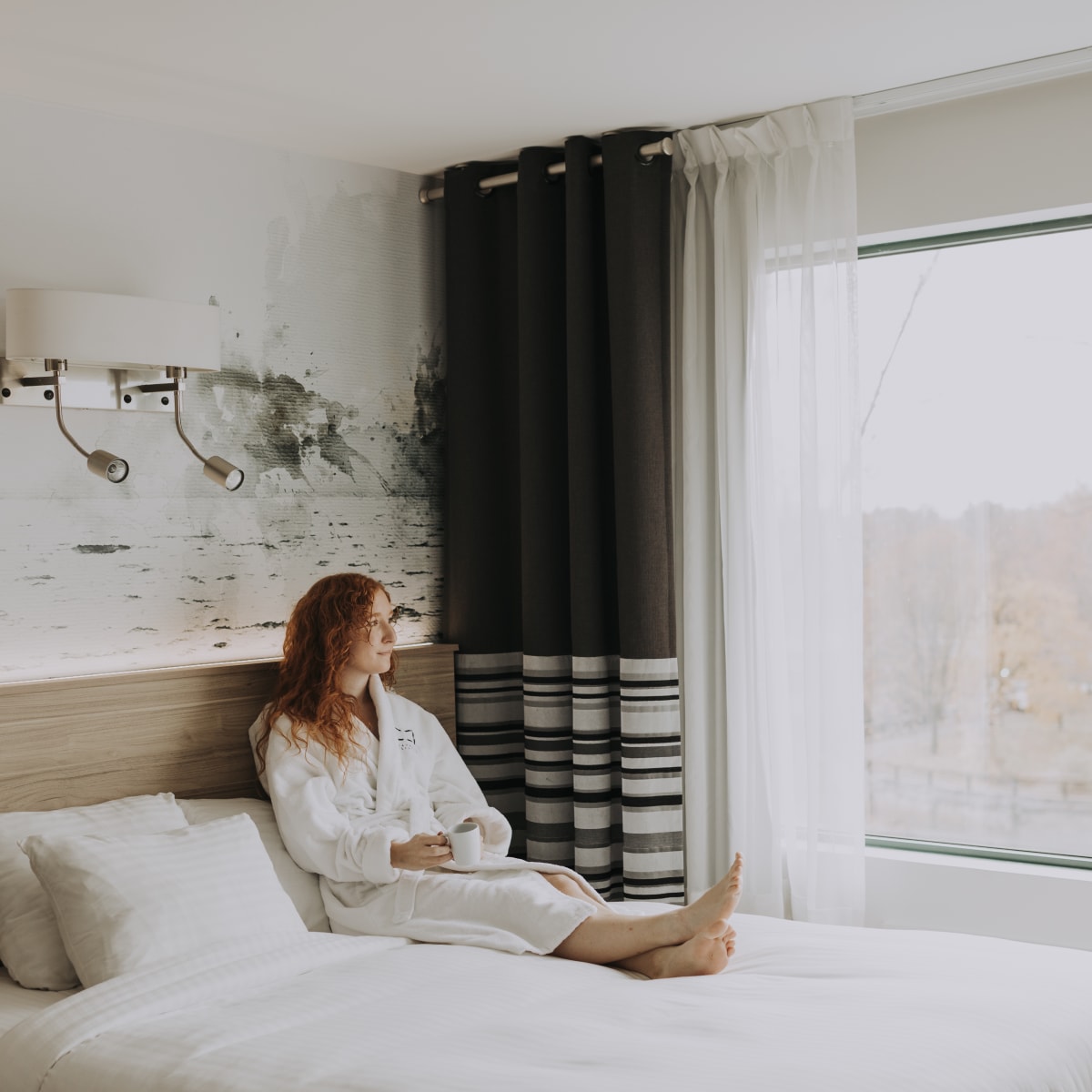 Woman in a bed at Château Joliette.
