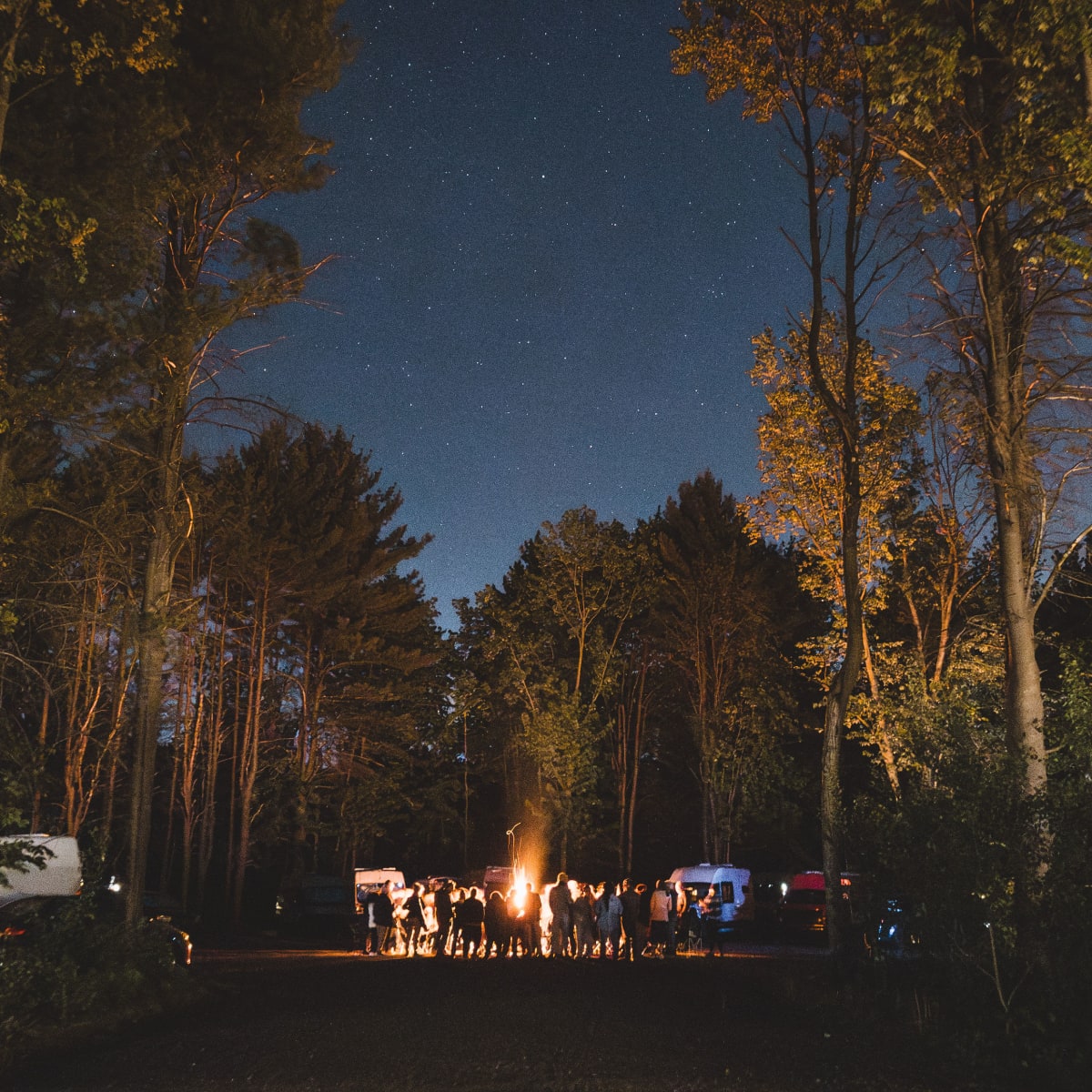 Group of people at a campsite in the evening