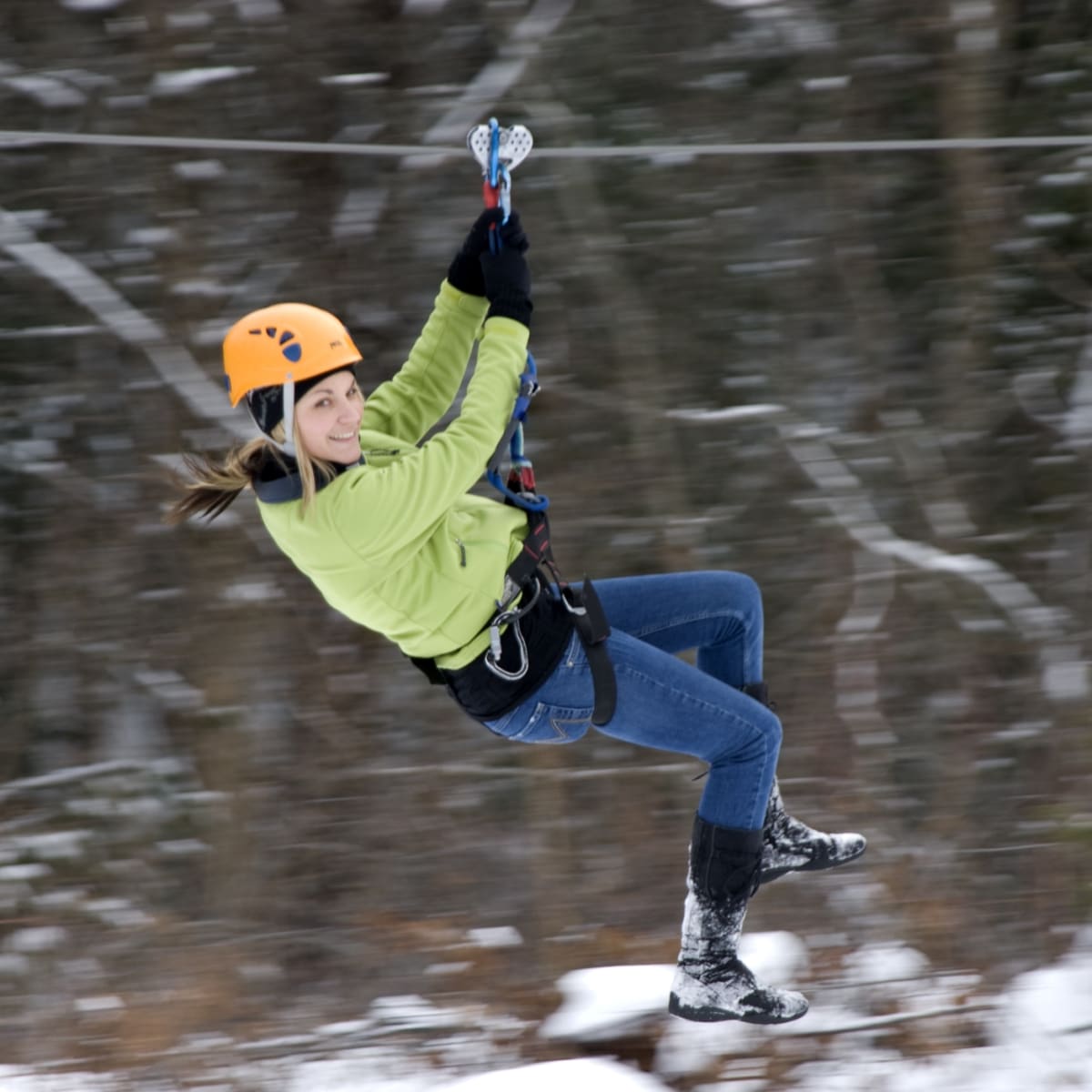 Woman on a zip line in winter.