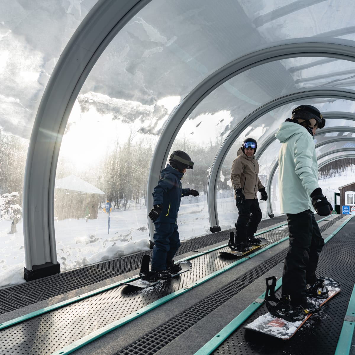 People on snowboards on a lift.