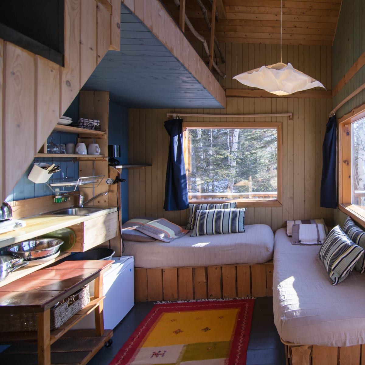 Interior view of a cabin with a canopy bed.