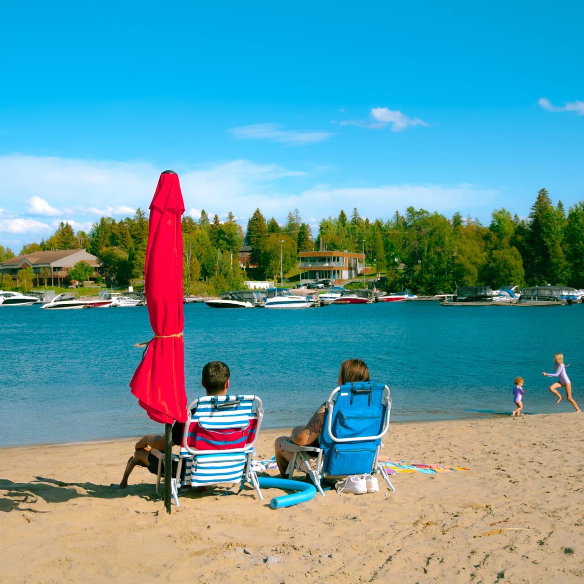 Centre de villégiature Dam-en-Terre - Deux personnes assises sur des chaises à la plage
