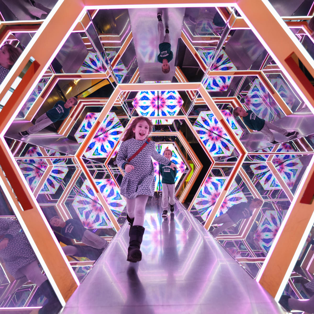 Two little girls having fun in the giant kaleidoscope.