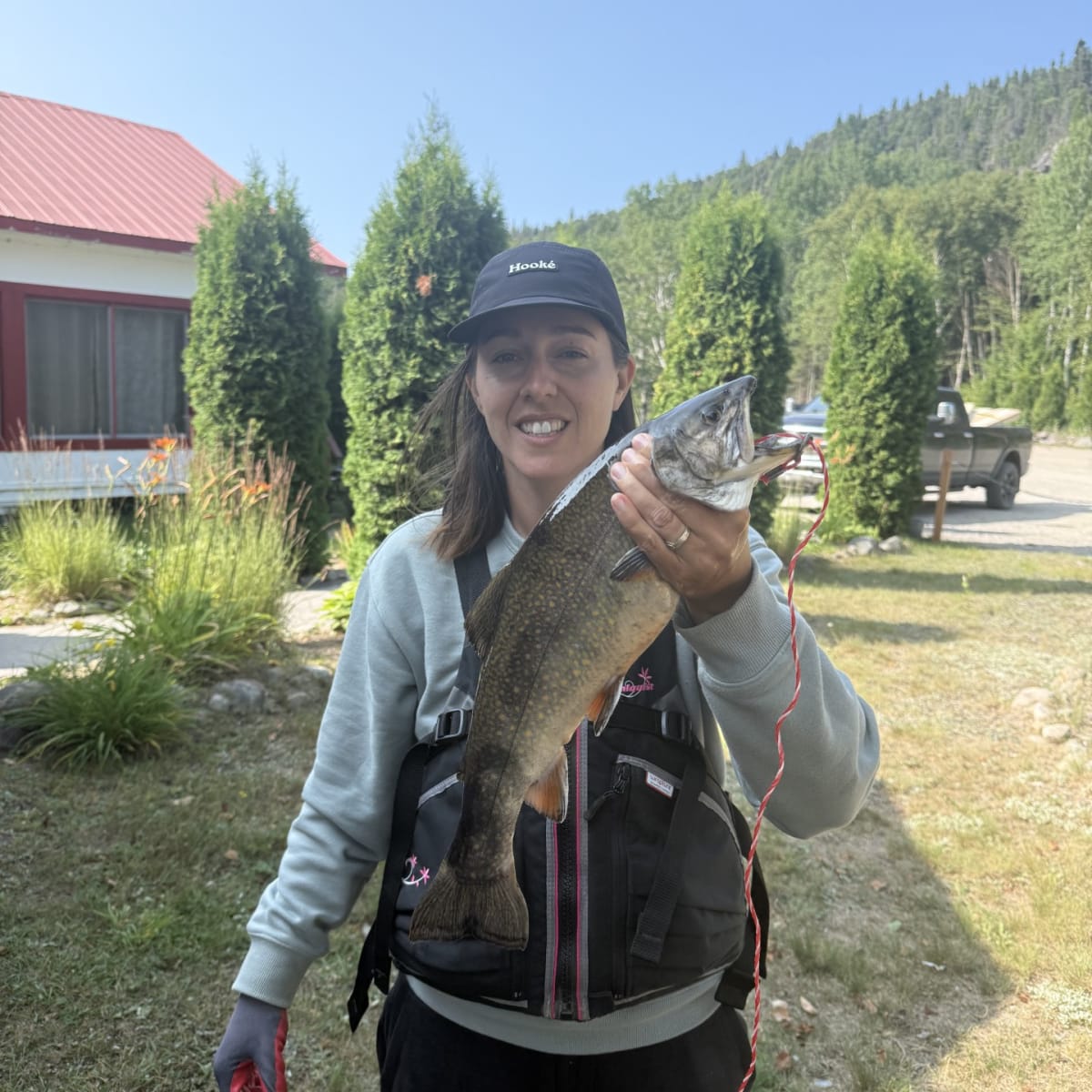A fisherwoman holding a fish.