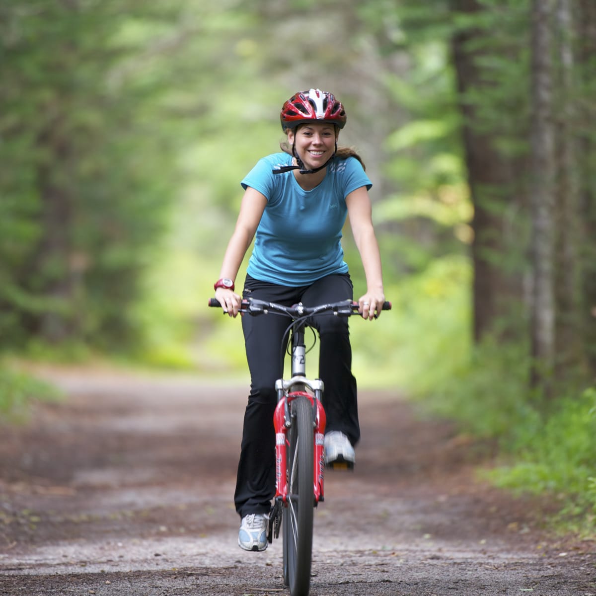 Woman cycling in the forest - Parc de la Mauricie