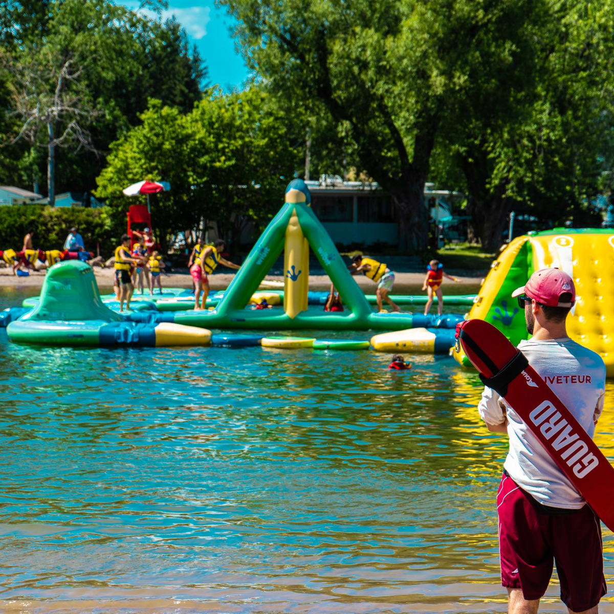 Domaine International de Rouville - A lifeguard looking towards a Wibit inflatable park