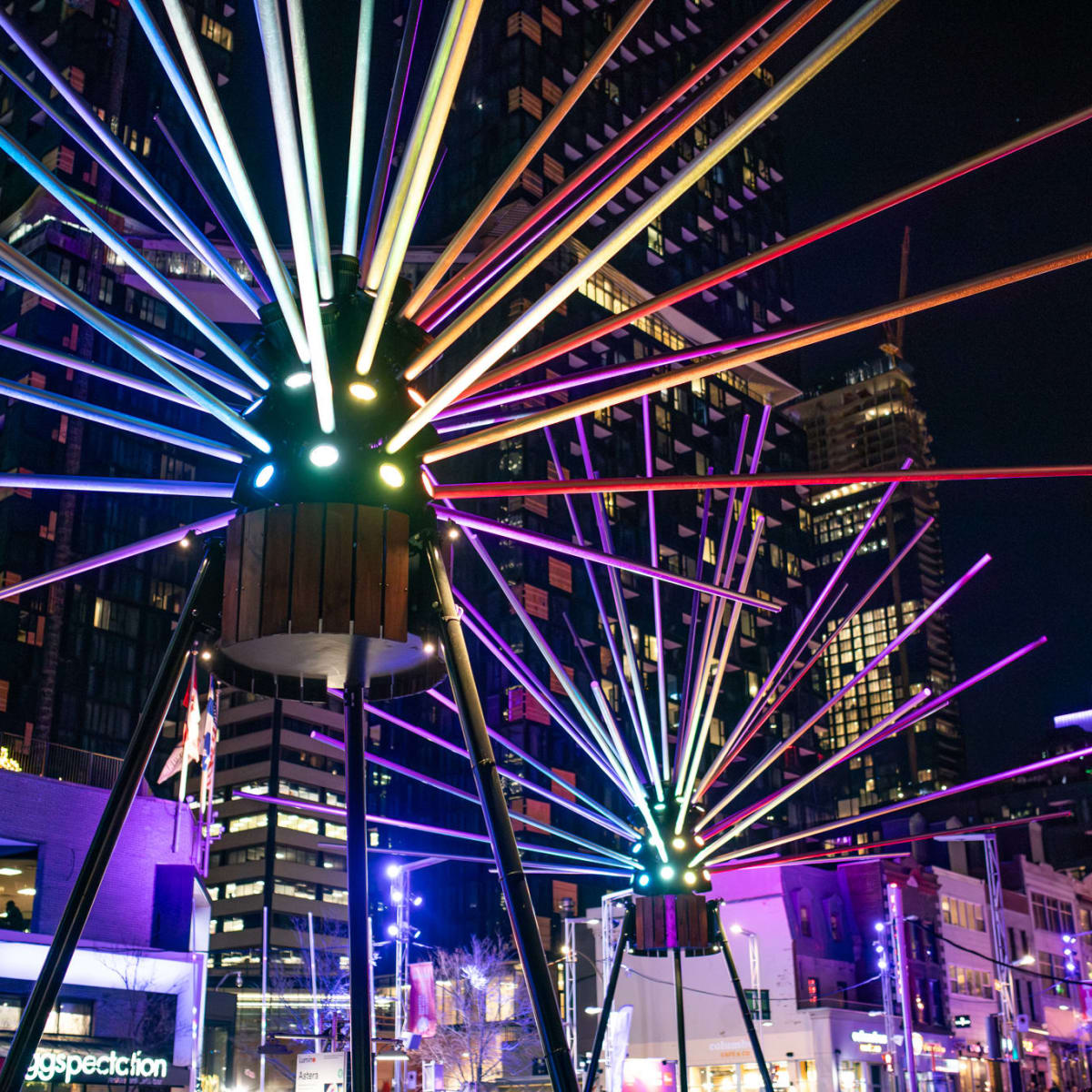 A colorful, illuminated structure on Place des Festivals in Montreal.