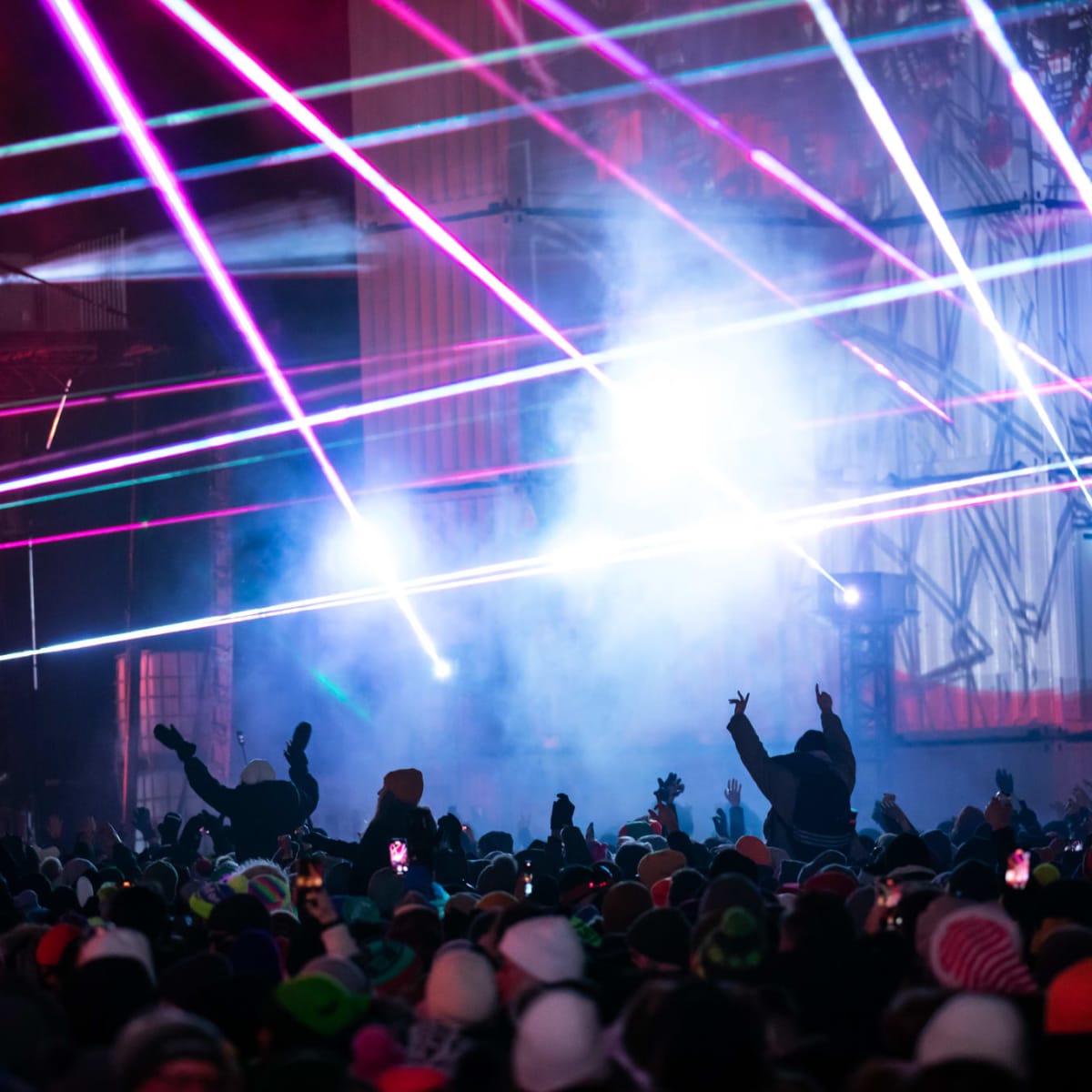 Laser show and the crowd at an electronic music festival. 