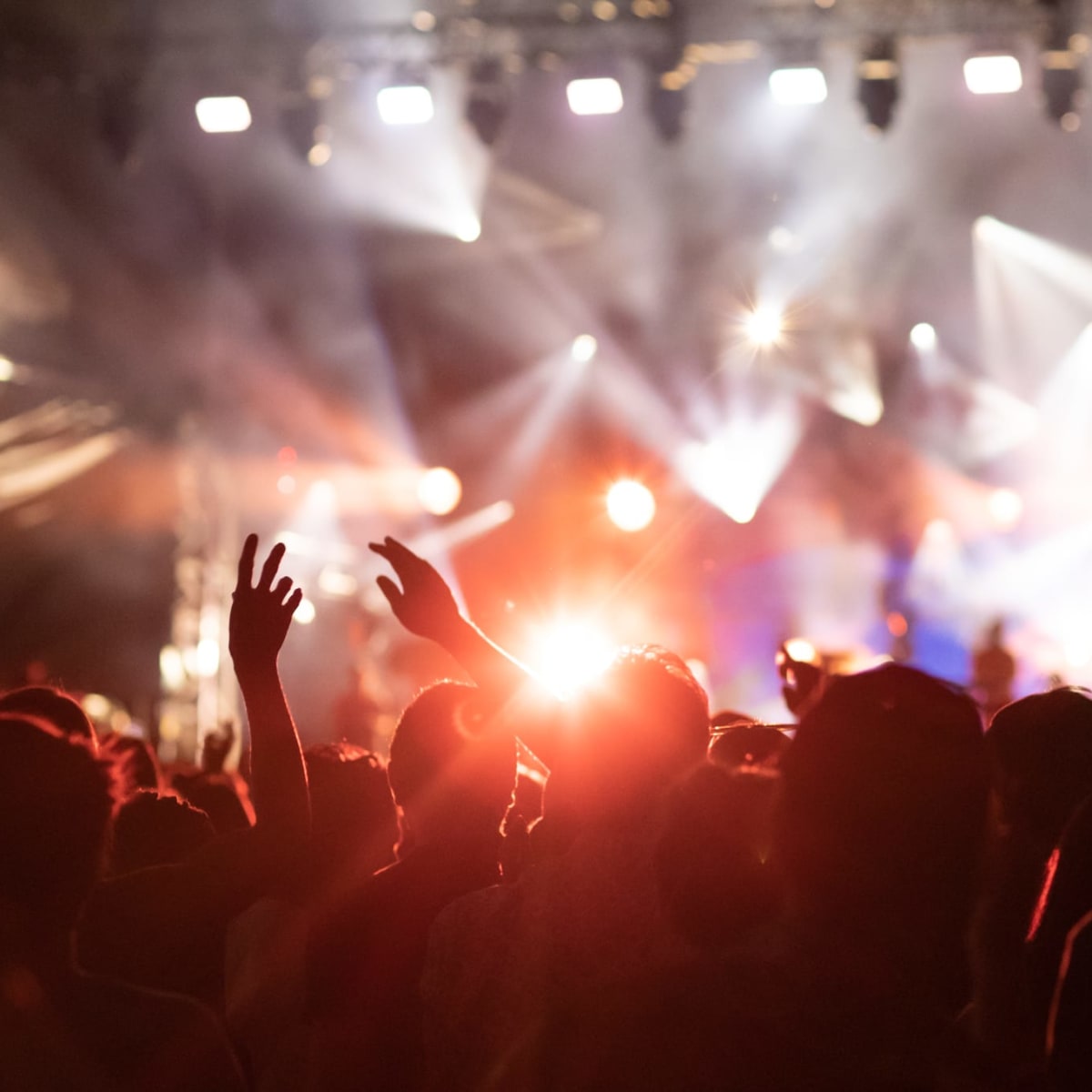 Festival-goers and a lit stage.