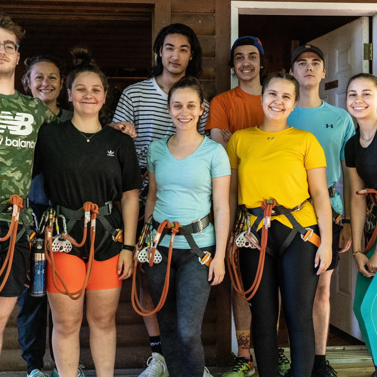 Group of people wearing climbing harnesses