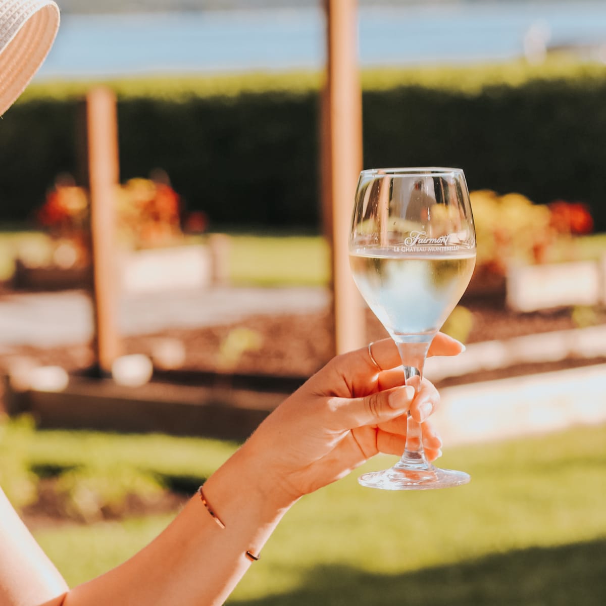 Close-up of a glass of white wine held by a woman