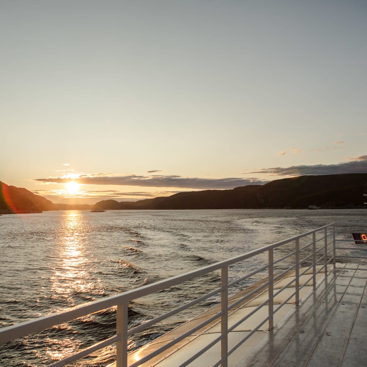 A ship's bridge with the sunset in the background.