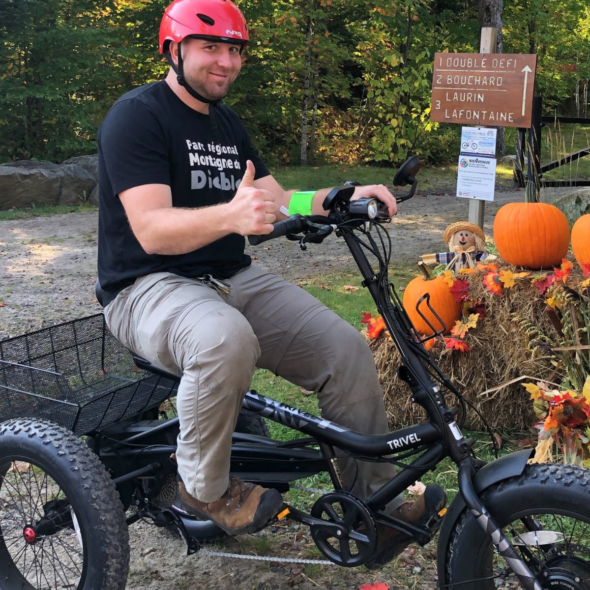 A man on a tricycle at the “Festival des Couleurs” in Parc régional Montagne du Diable.