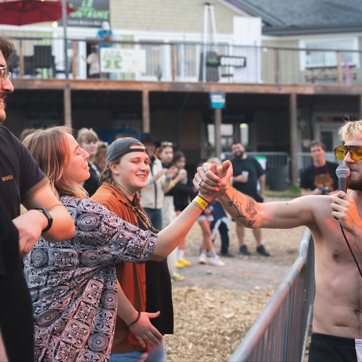 FOCUS Festival - A man with a microphone is holding a woman's hand.