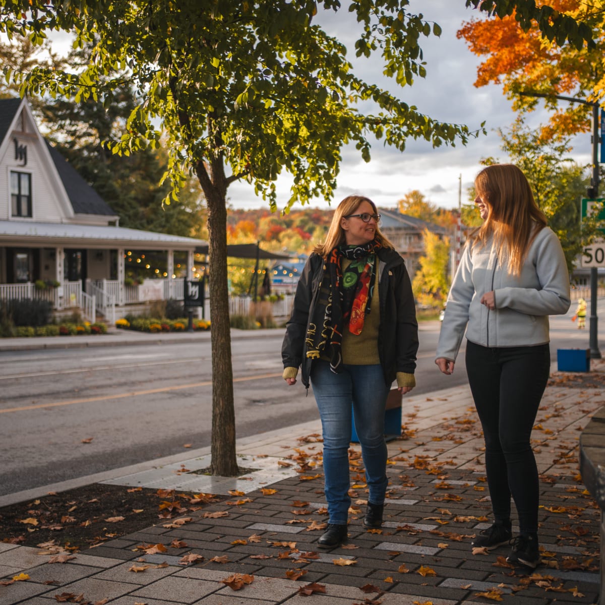 Two women walking in a charming town