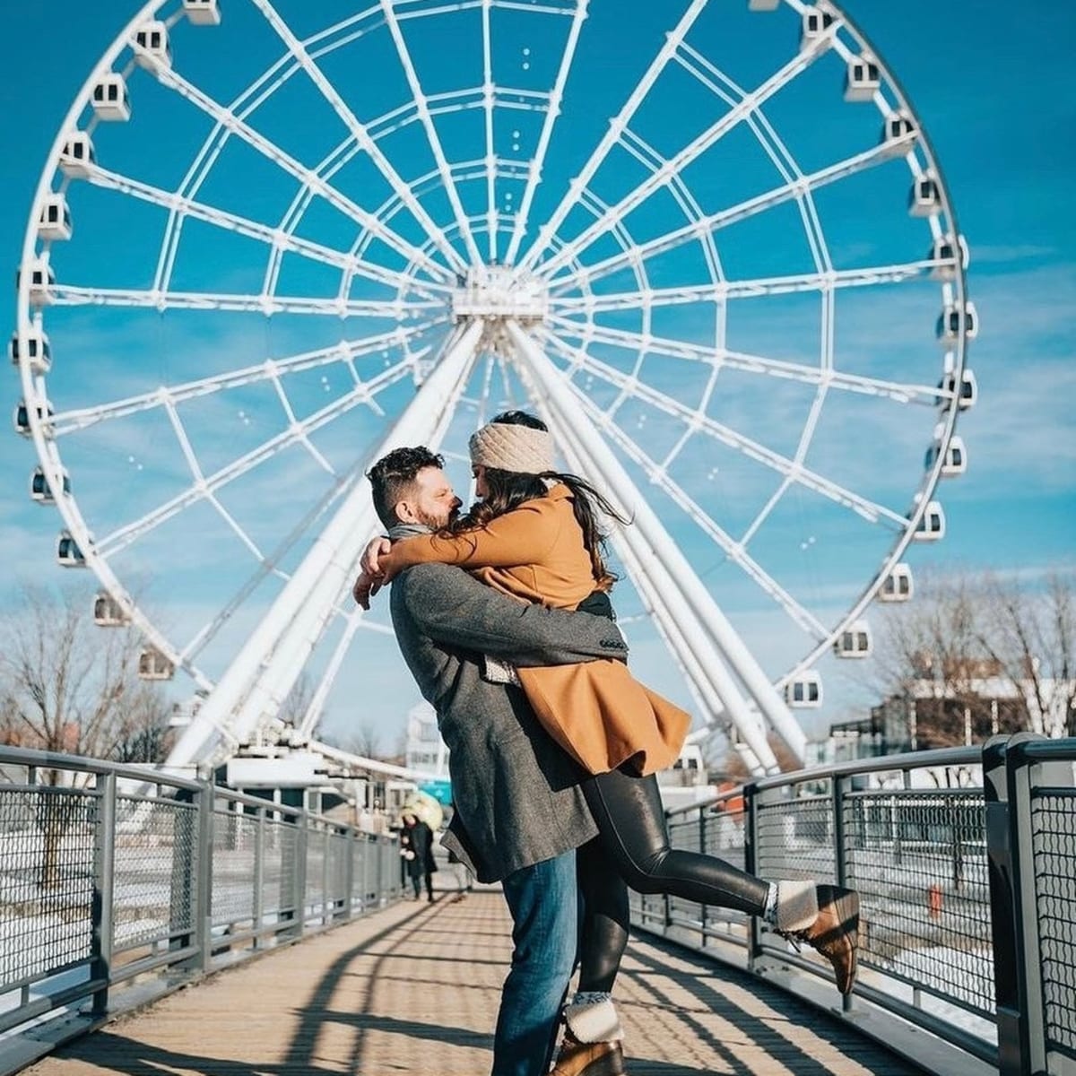 Couple in front of Grande Roue of Montreal.