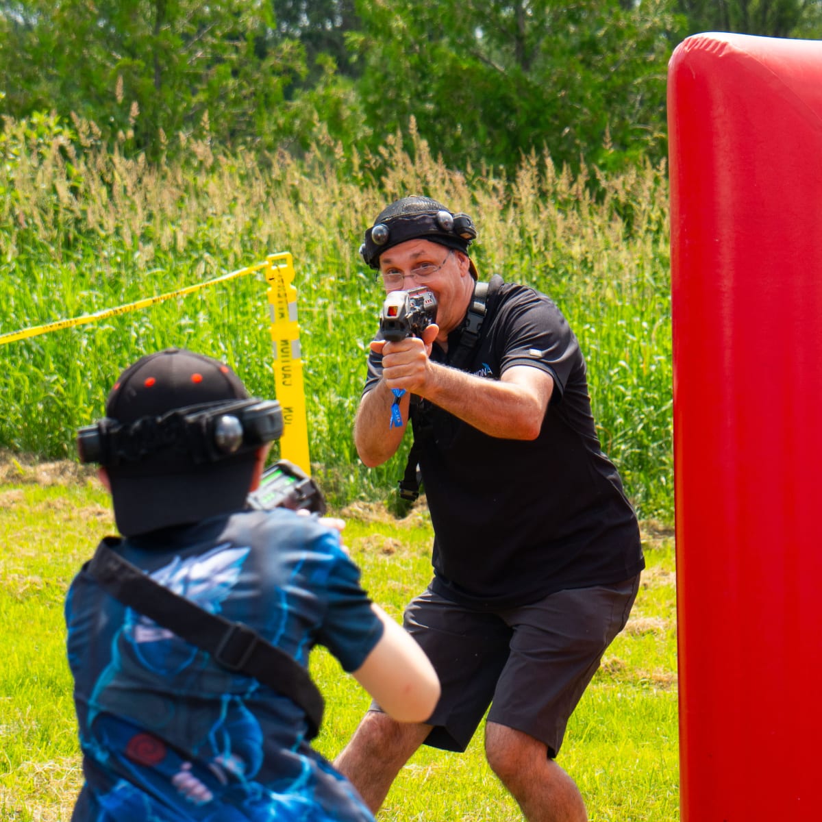 Two people playing paintball.