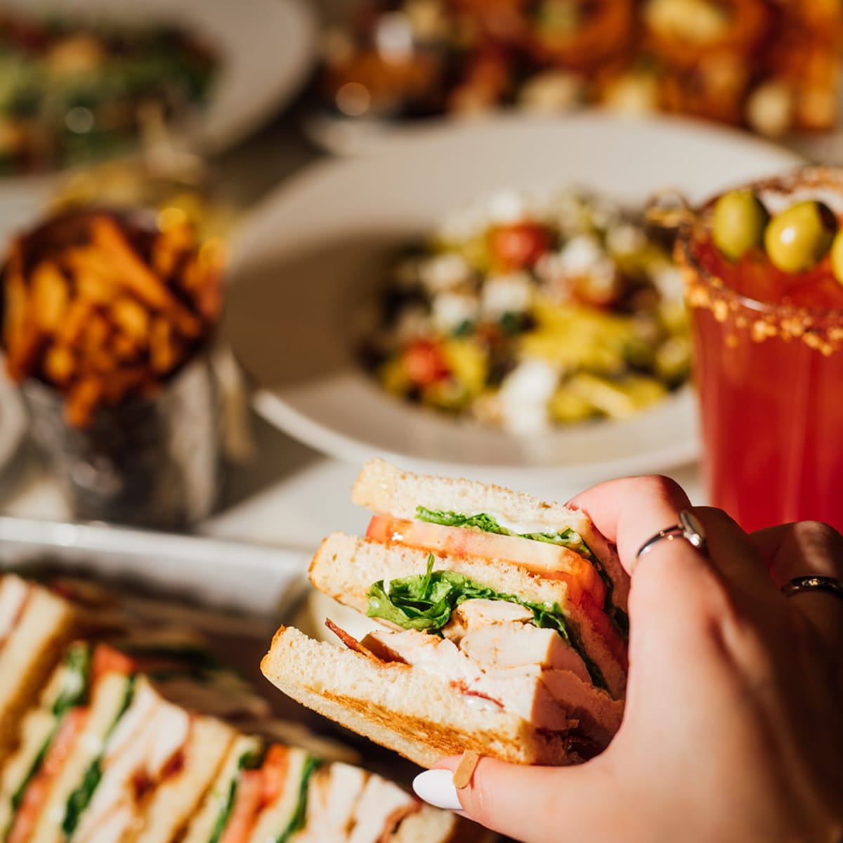 A club sandwich with a Bloody Caesar.