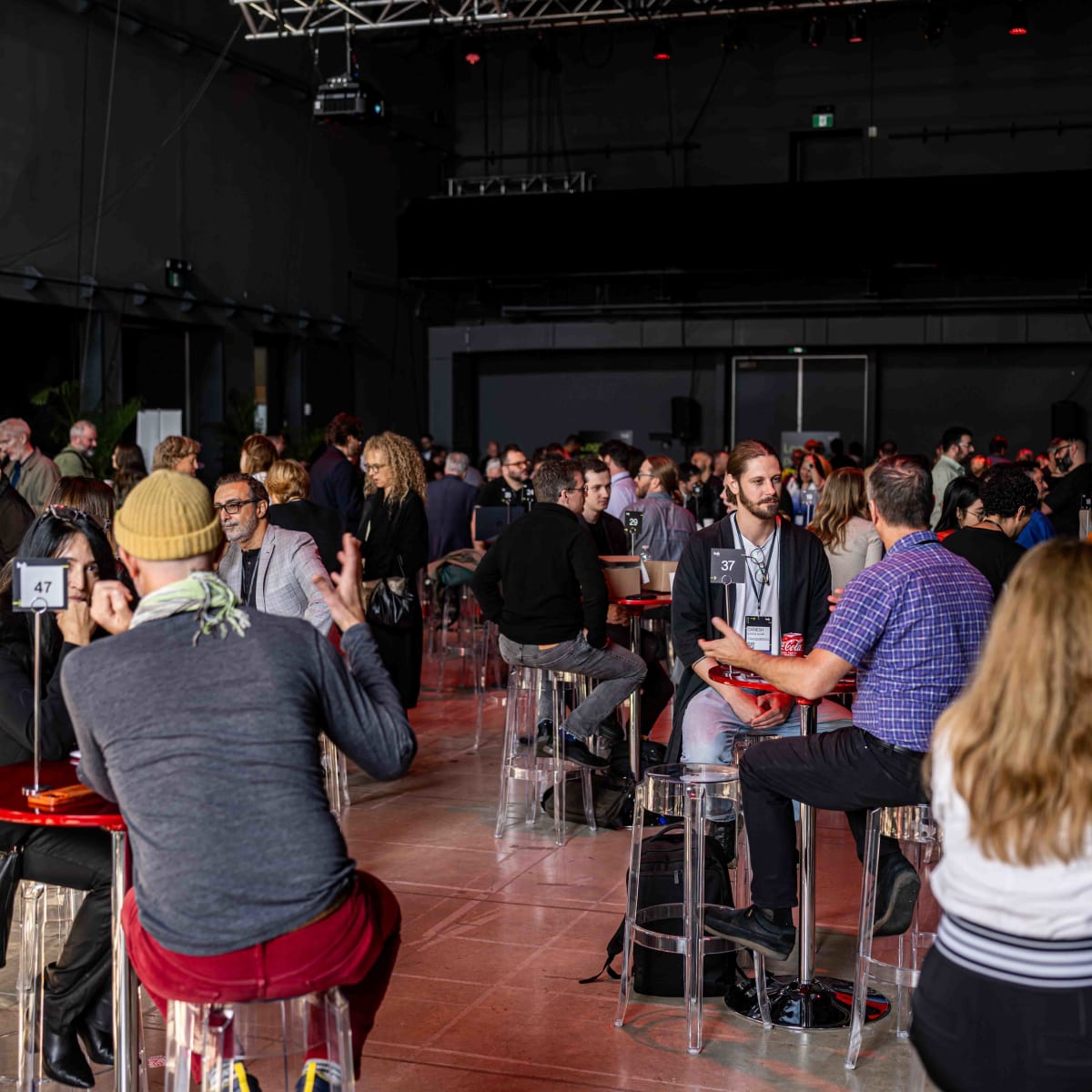 Hub Montréal - Several people are seated around round tables