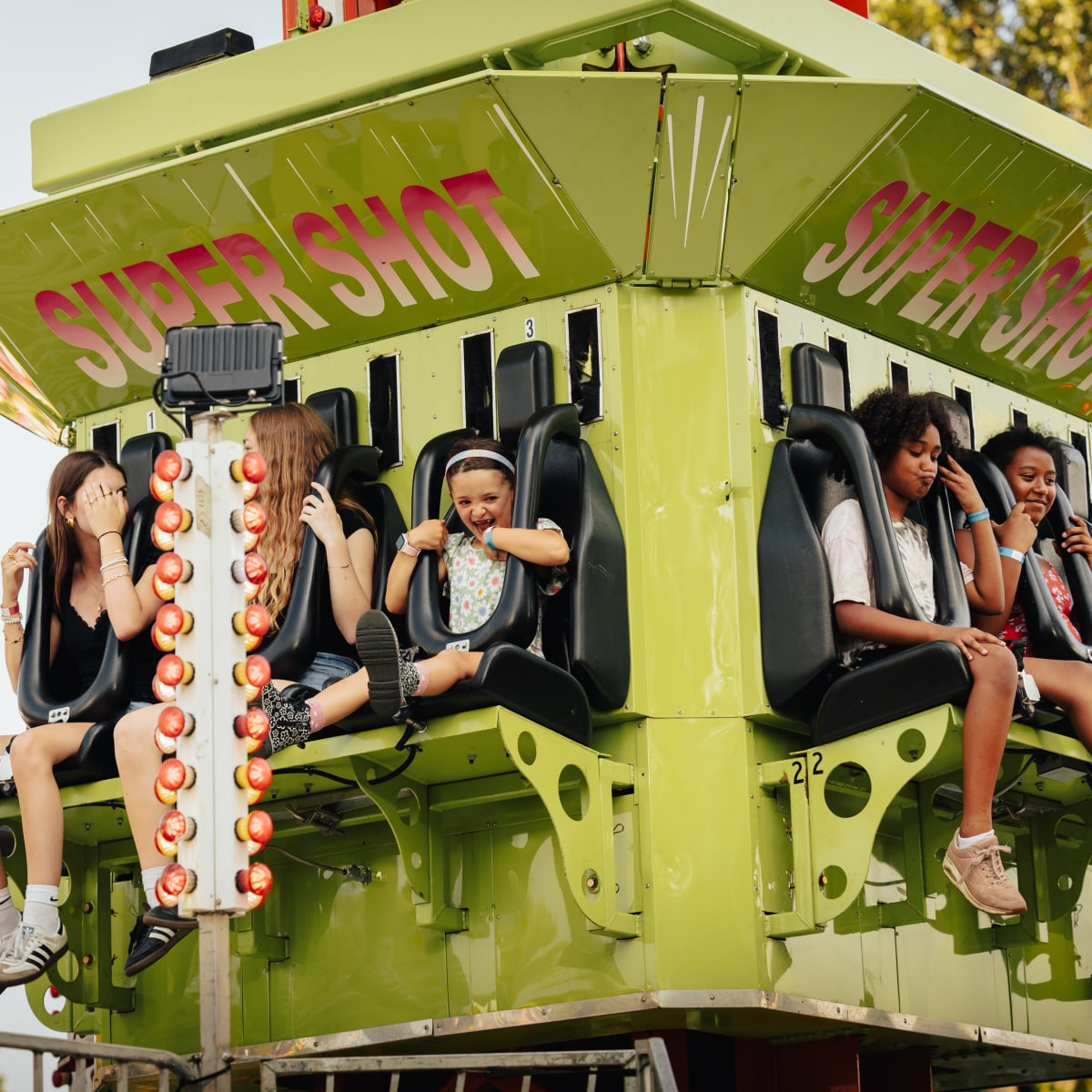 Kids in an amusement park ride at Fête du Lac des Nations.