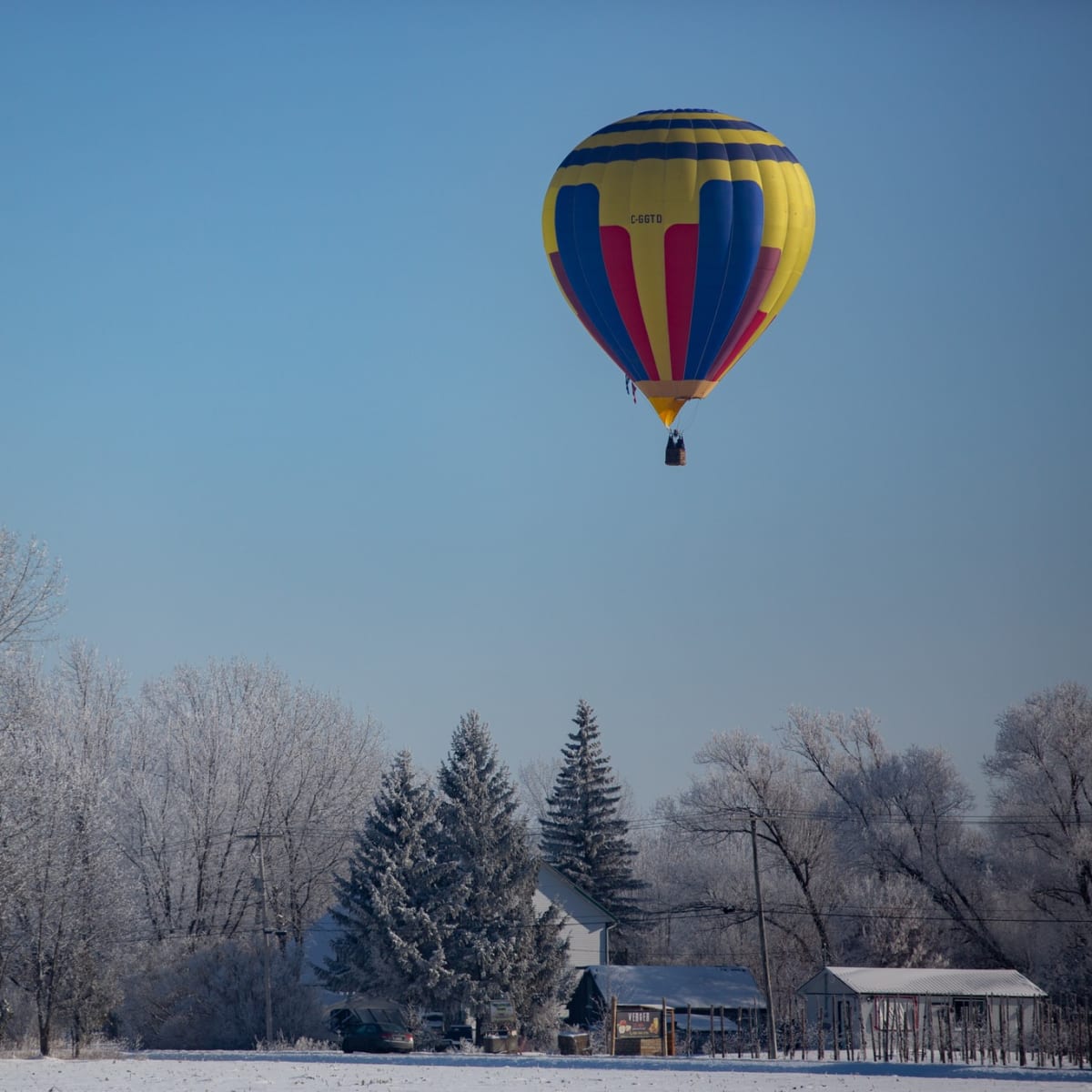 Hot air balloon flight in a winter landscape.
