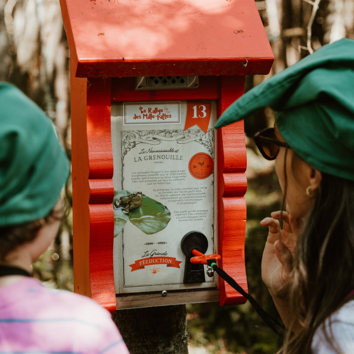 Kids with gnome hats on a treasure hunt in the forest.