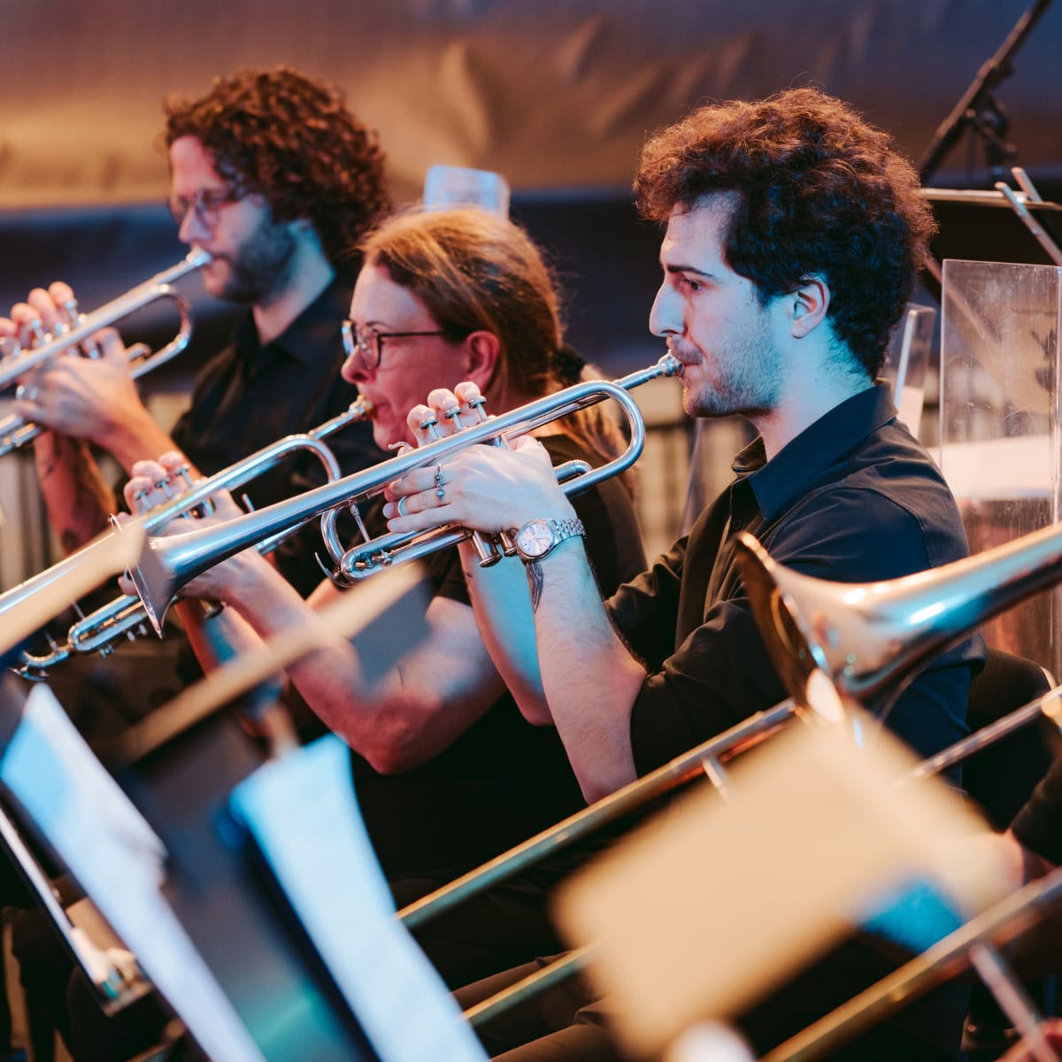 The Metropolitan Orchestra playing instruments.