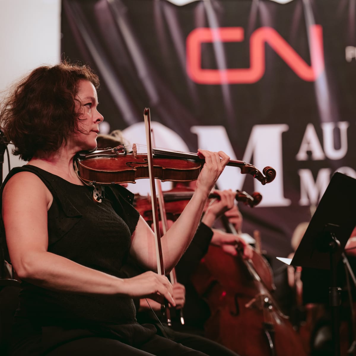 The Metropolitan Orchestra playing instruments.