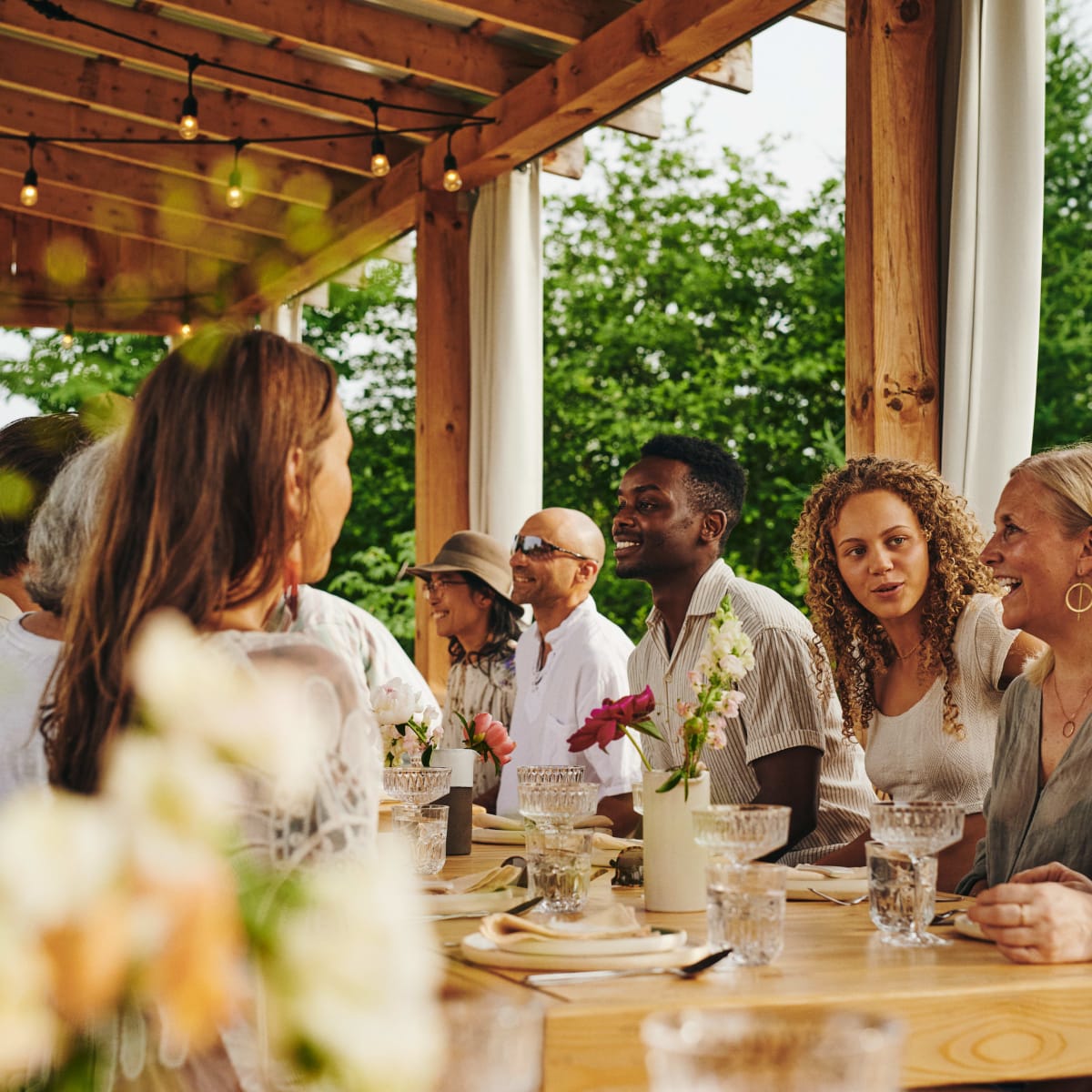 A group of friends having dinner in the summer.