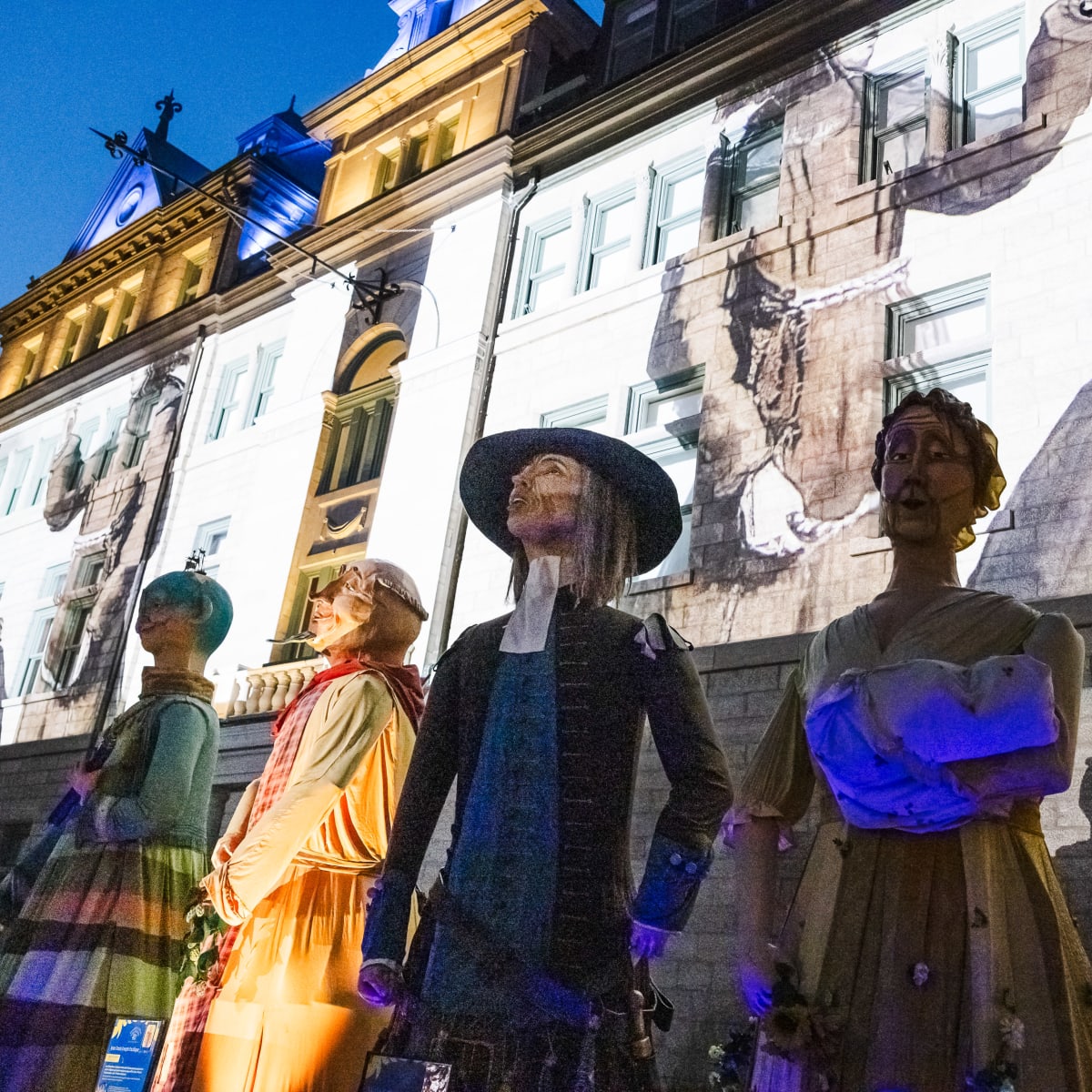 Les Fêtes de la Nouvelle-France - A row of giant figures.