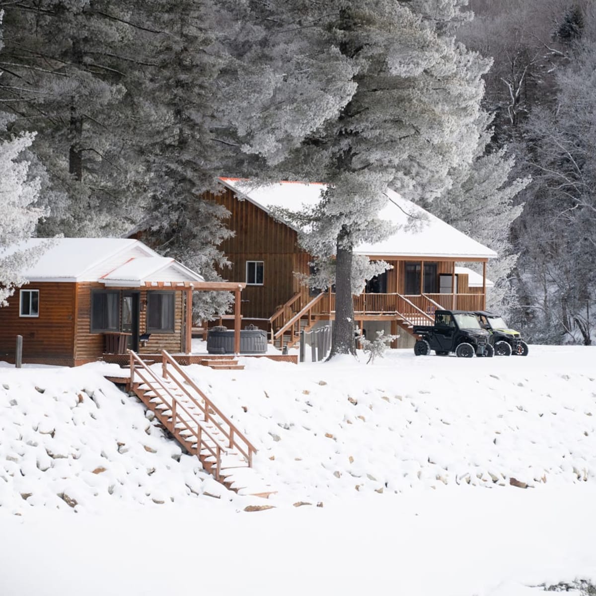 Two small cabins in a snowy setting.