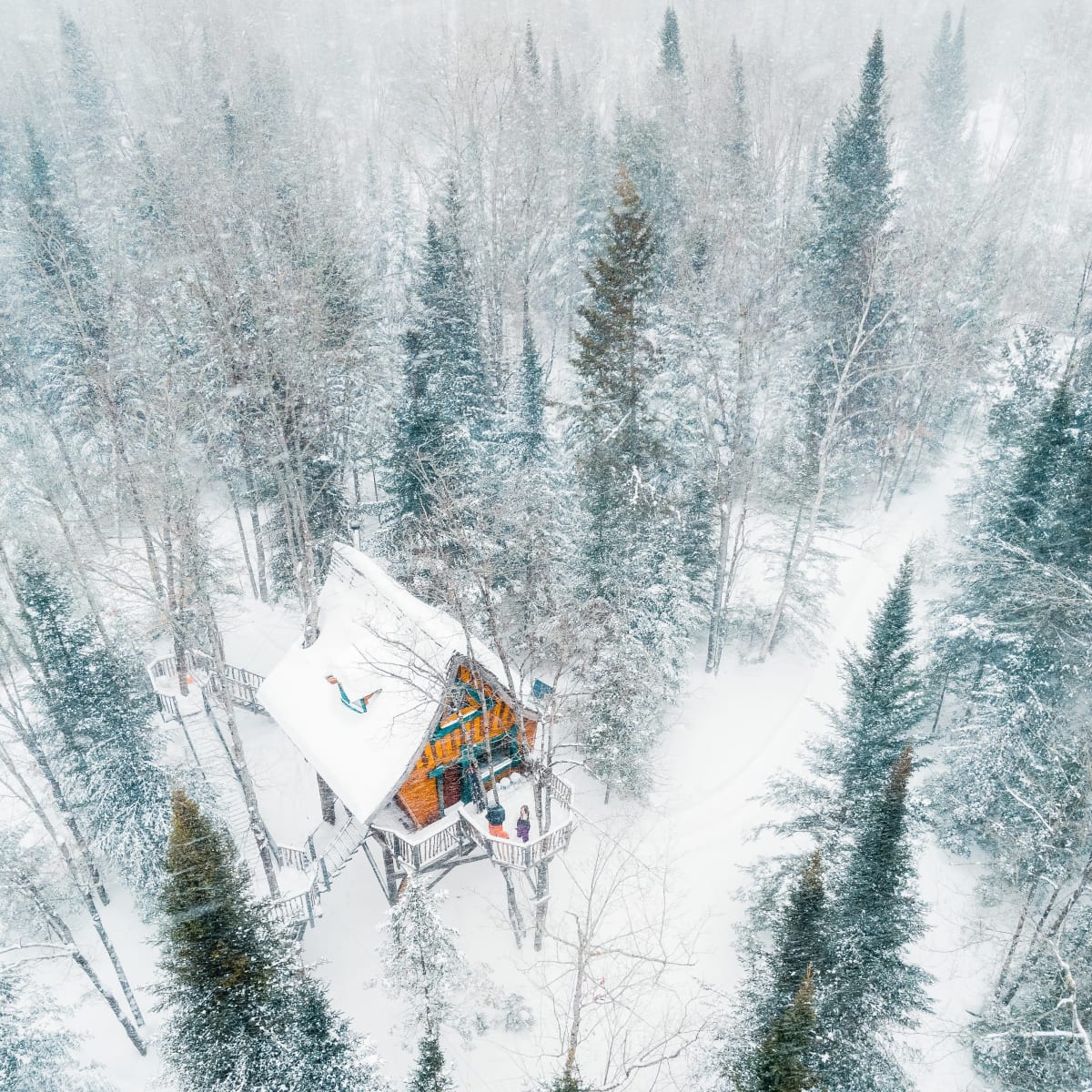 An enchanted chalet covered in snow.