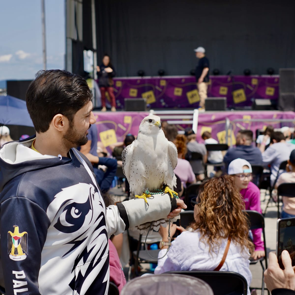 A man with a bird of prey on his arm at the Levisium Science Festival 2026 in Quebec City.