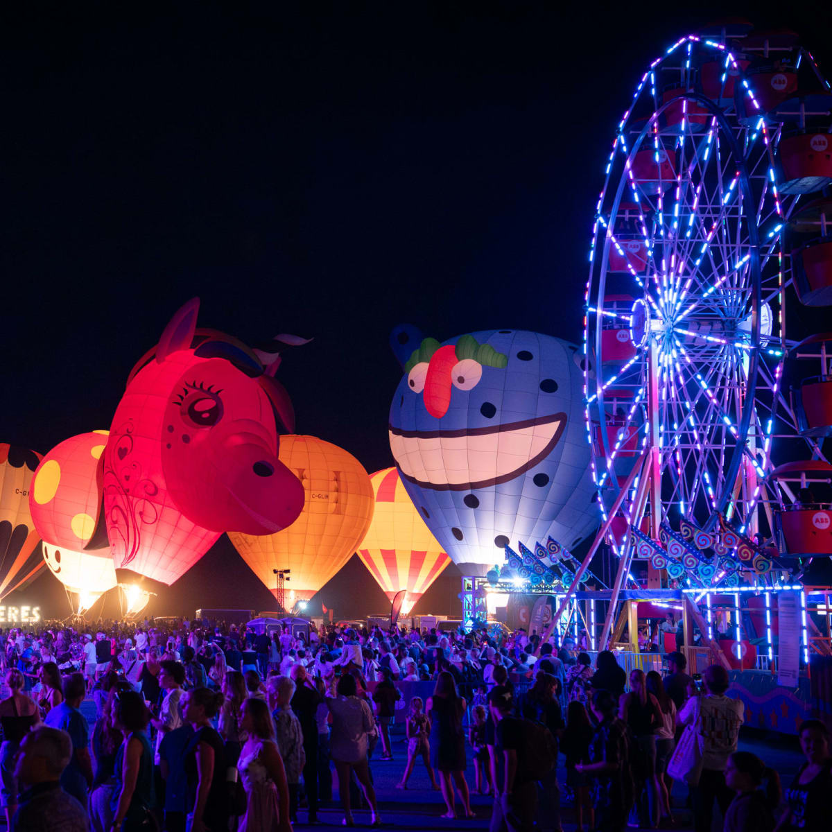 Hot air balloons lit up at night at the International Balloon Festival of Saint-Jean-sur-Richelieu.