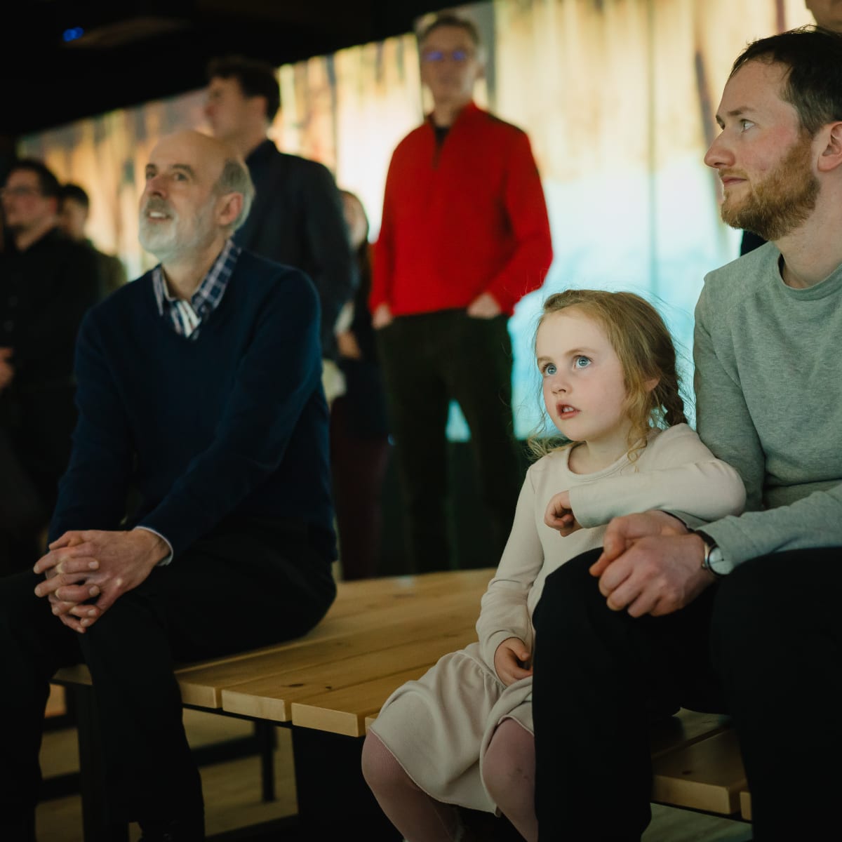 Family looking at an exhibit at the Centre d'exposition du Marais de la Rivière-aux-Cerises.