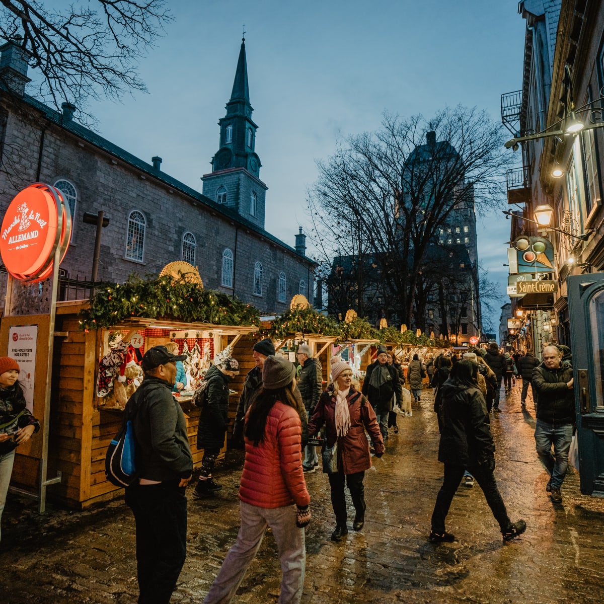 Quebec City German Christmas Market - Small booths decorated with garlands of lights are arranged along the street.