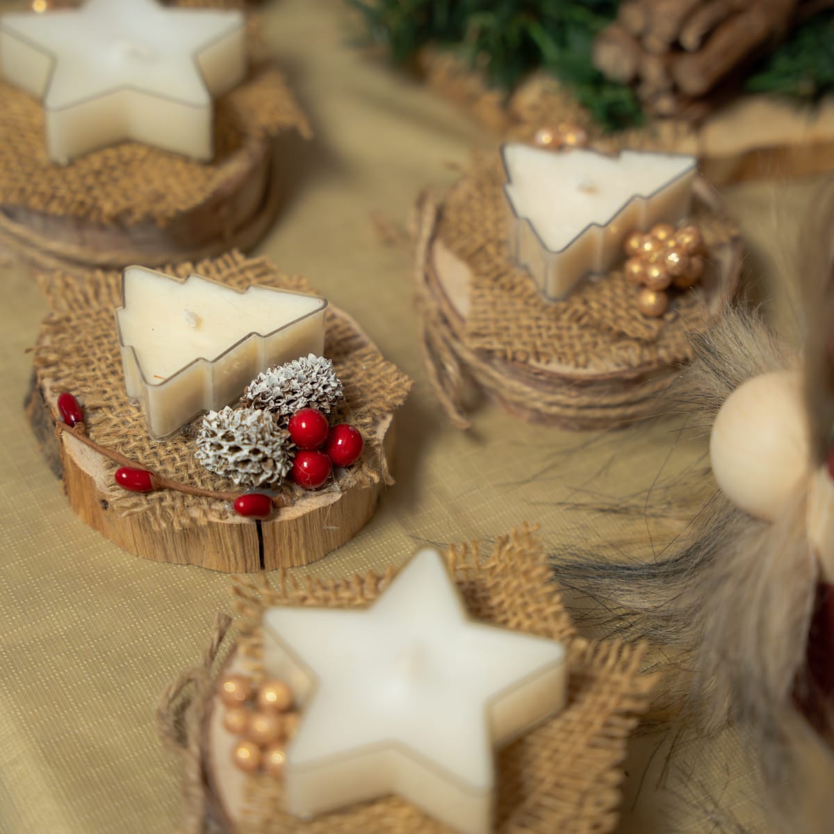 White Christmas candles shaped like trees and stars.
