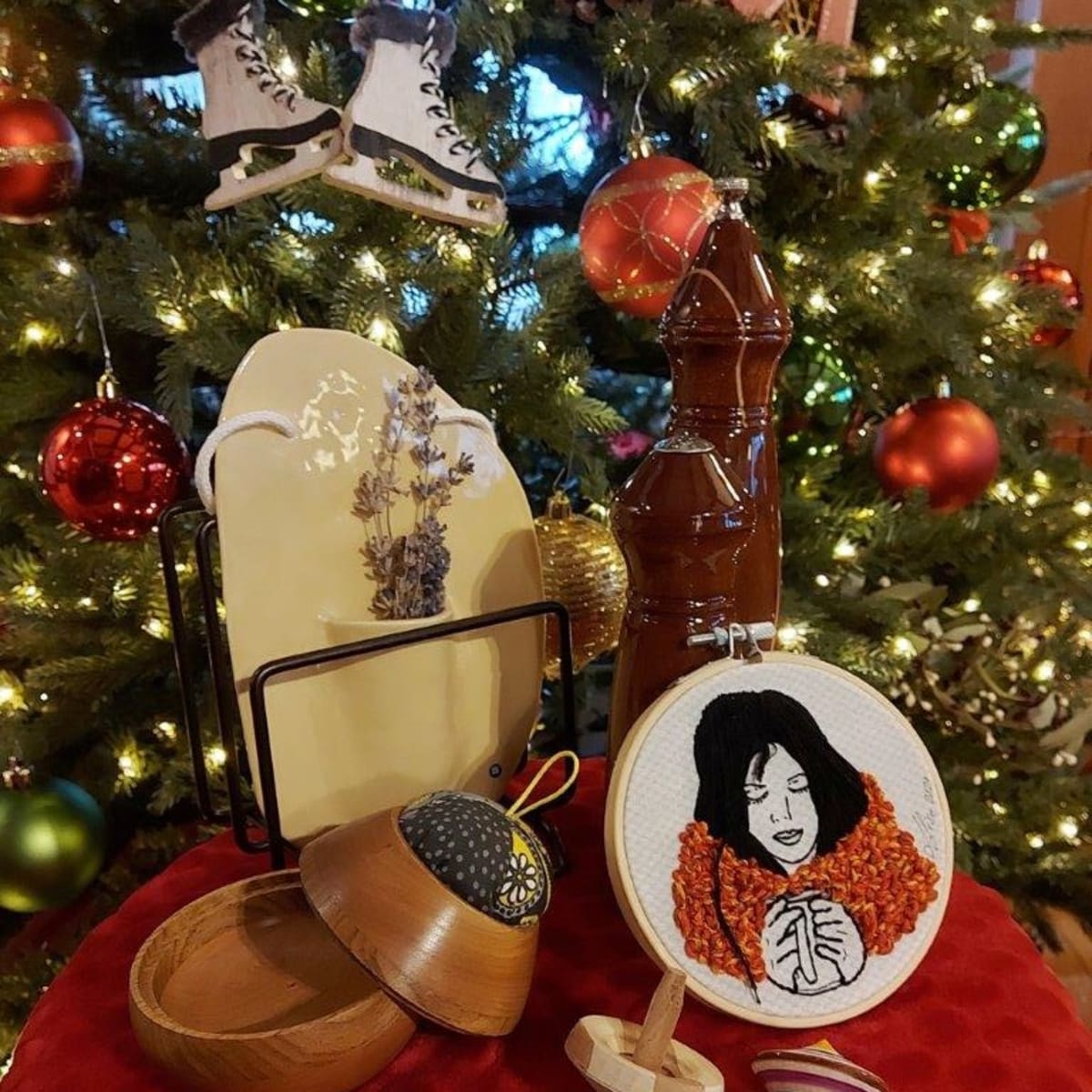 Several artisans’ creations displayed in front of a decorated Christmas tree.