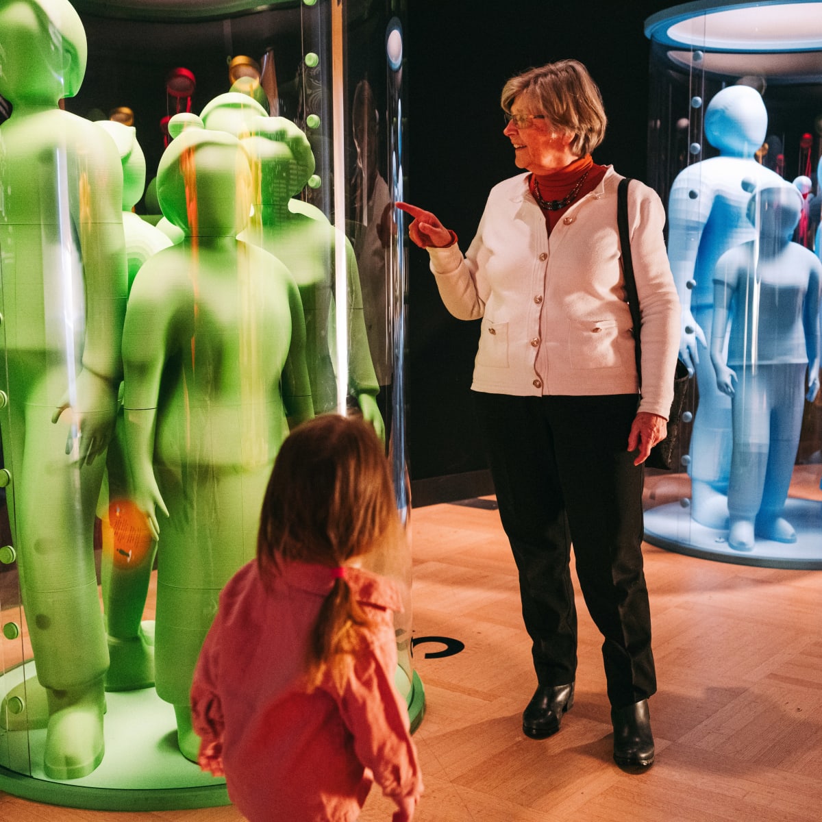 A grandmother and her granddaughter admiring an exhibition.