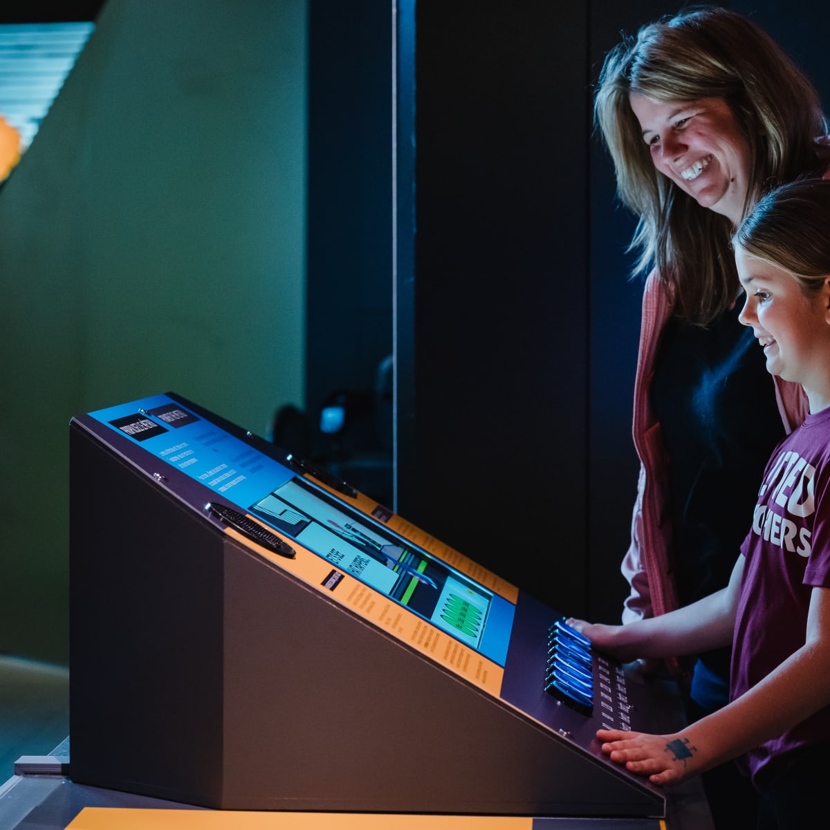 Mother and her daughter in front of a screen
