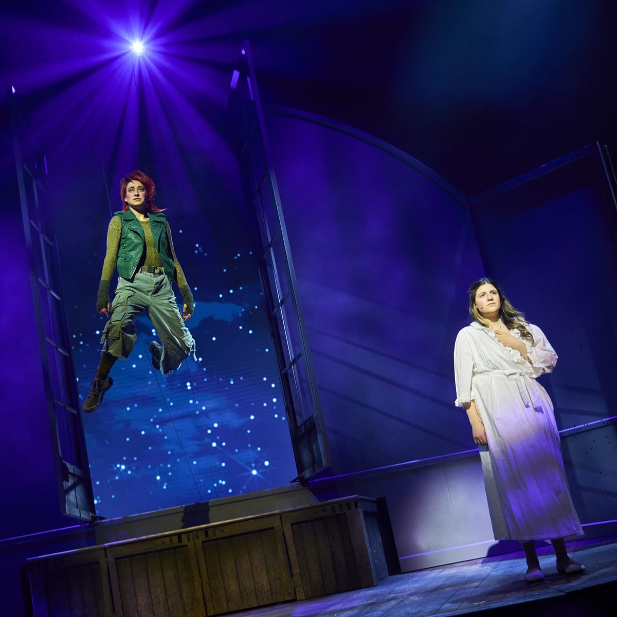 Peter Pan flying past the window and Wendy in her room. 