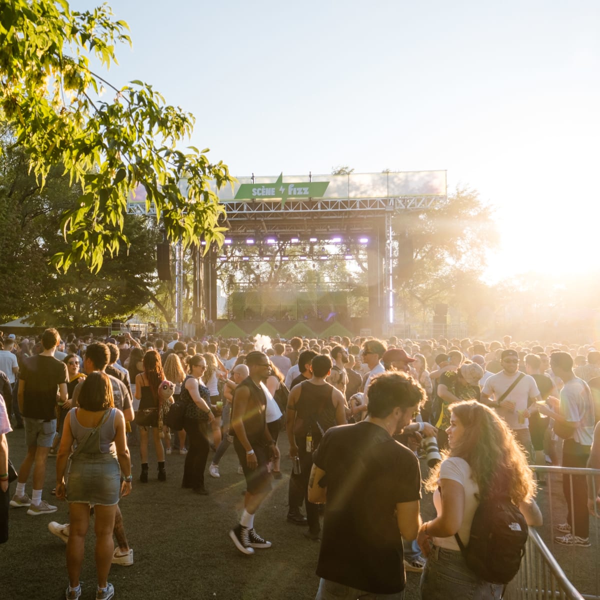 A crowd gathered in front of the stage in the late afternoon.