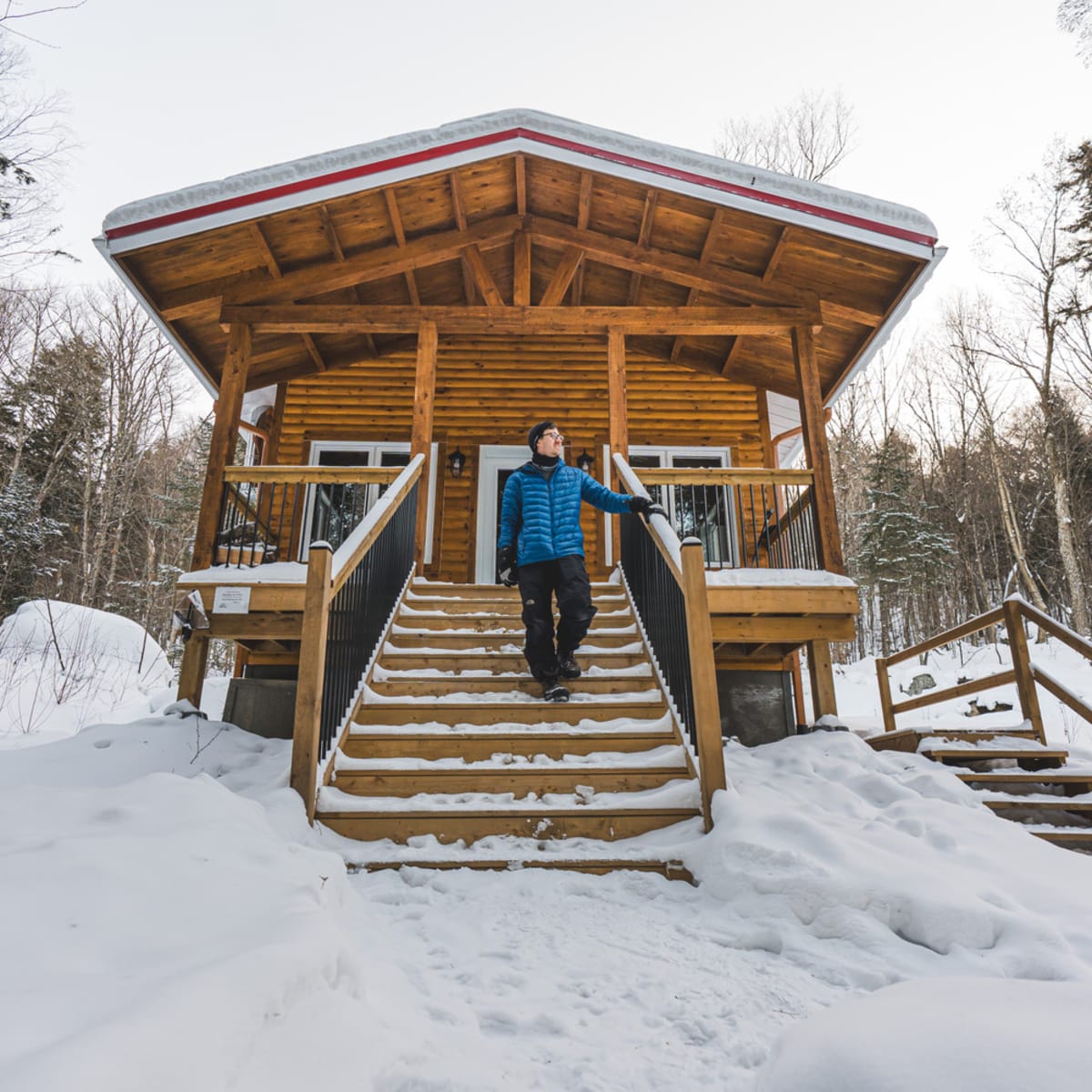 Homme devant un chalet.