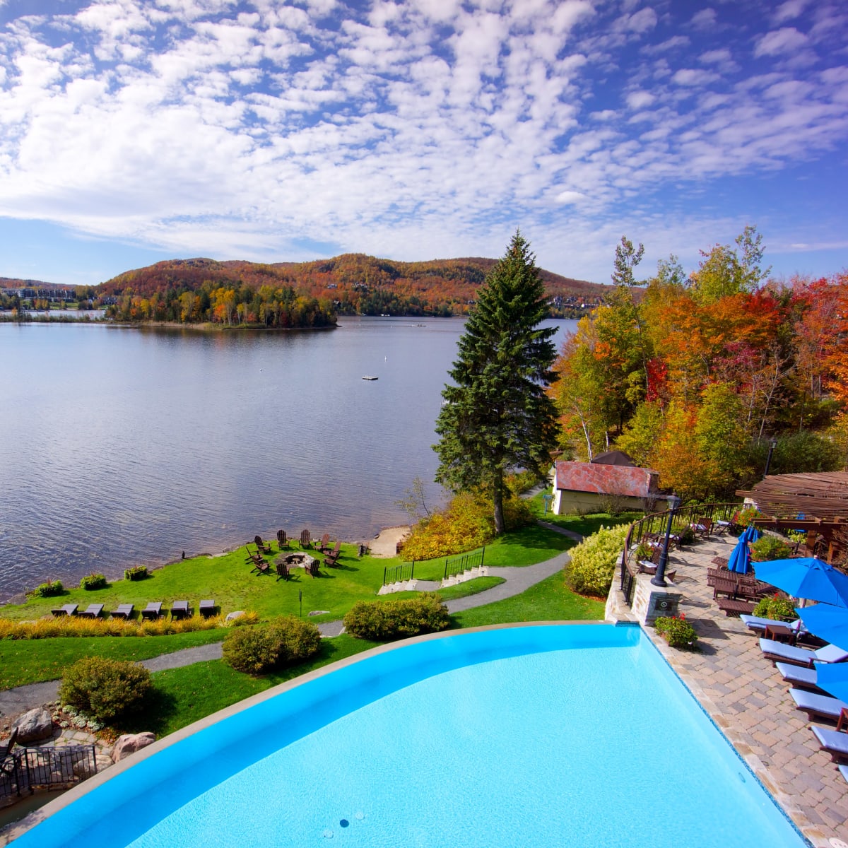 A hotel's pool and lake in the fall.