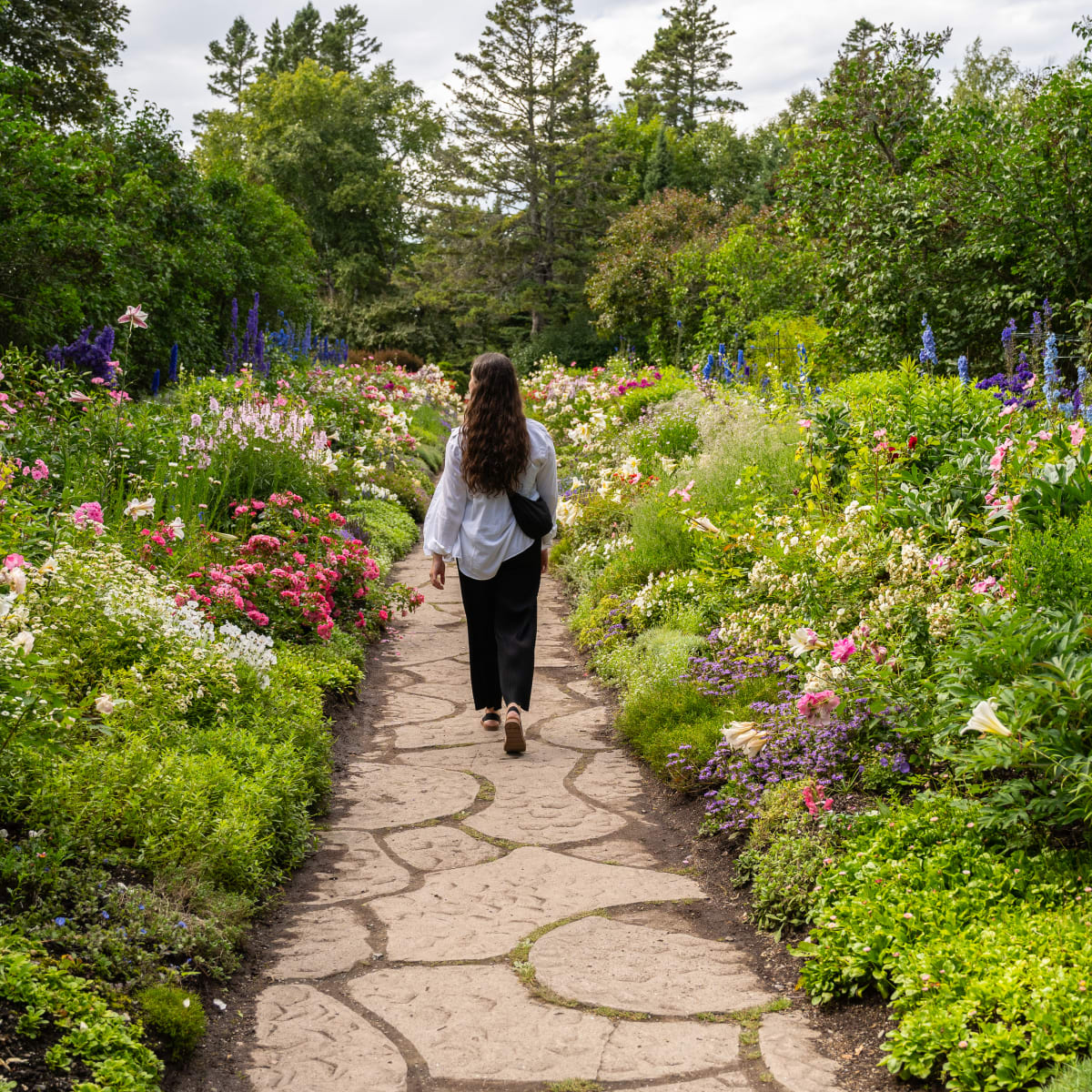 Woman on a trail in a garden.